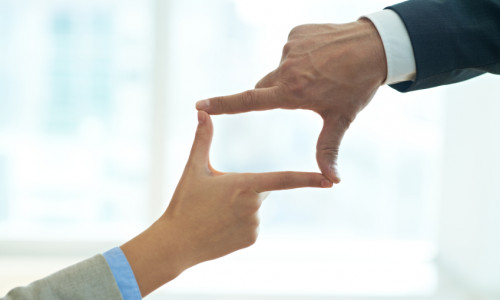Framing hands Businessman and businesswoman doing finger frame together